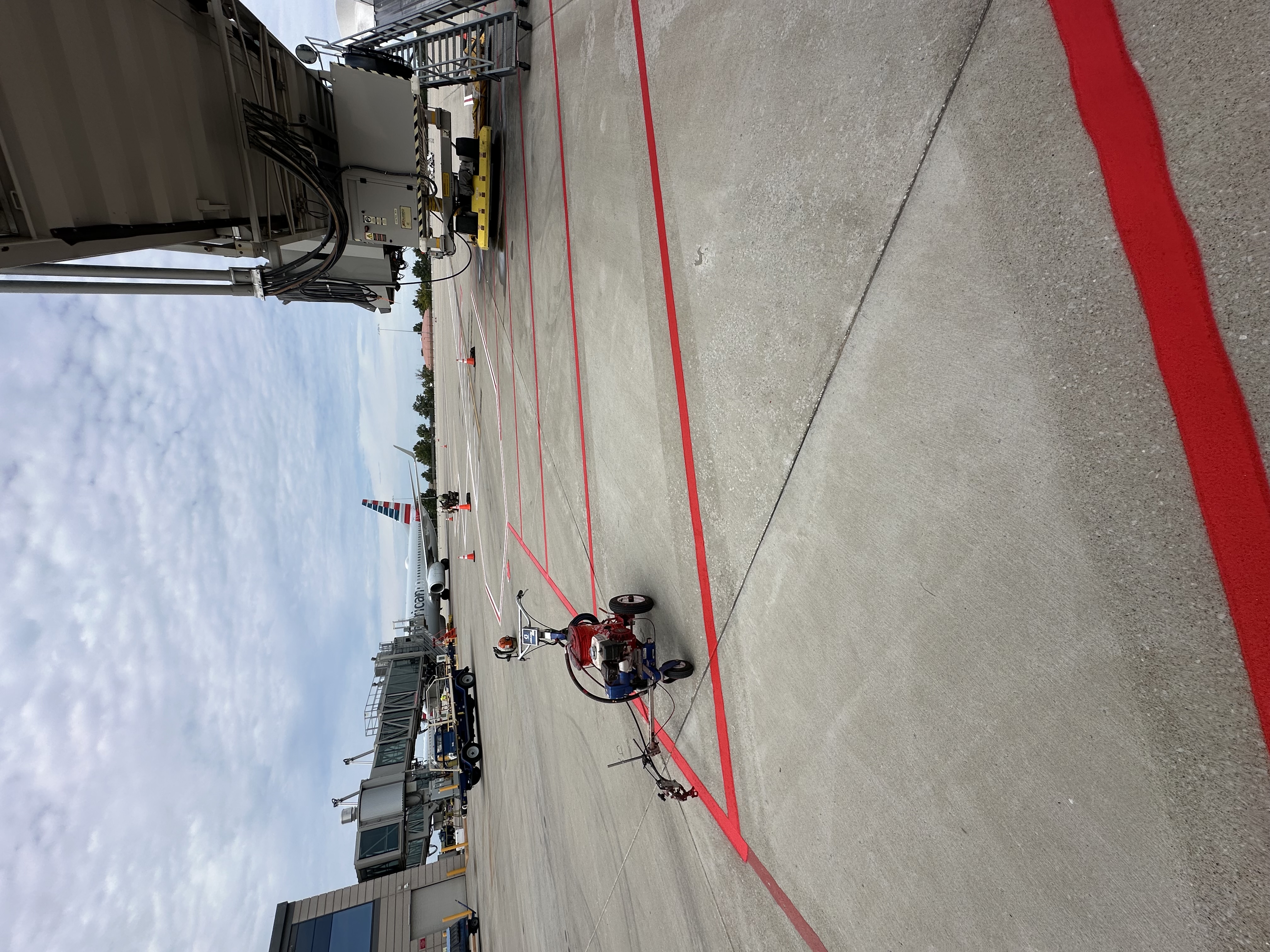 Striping equipment beside fresh red ramp safety lines