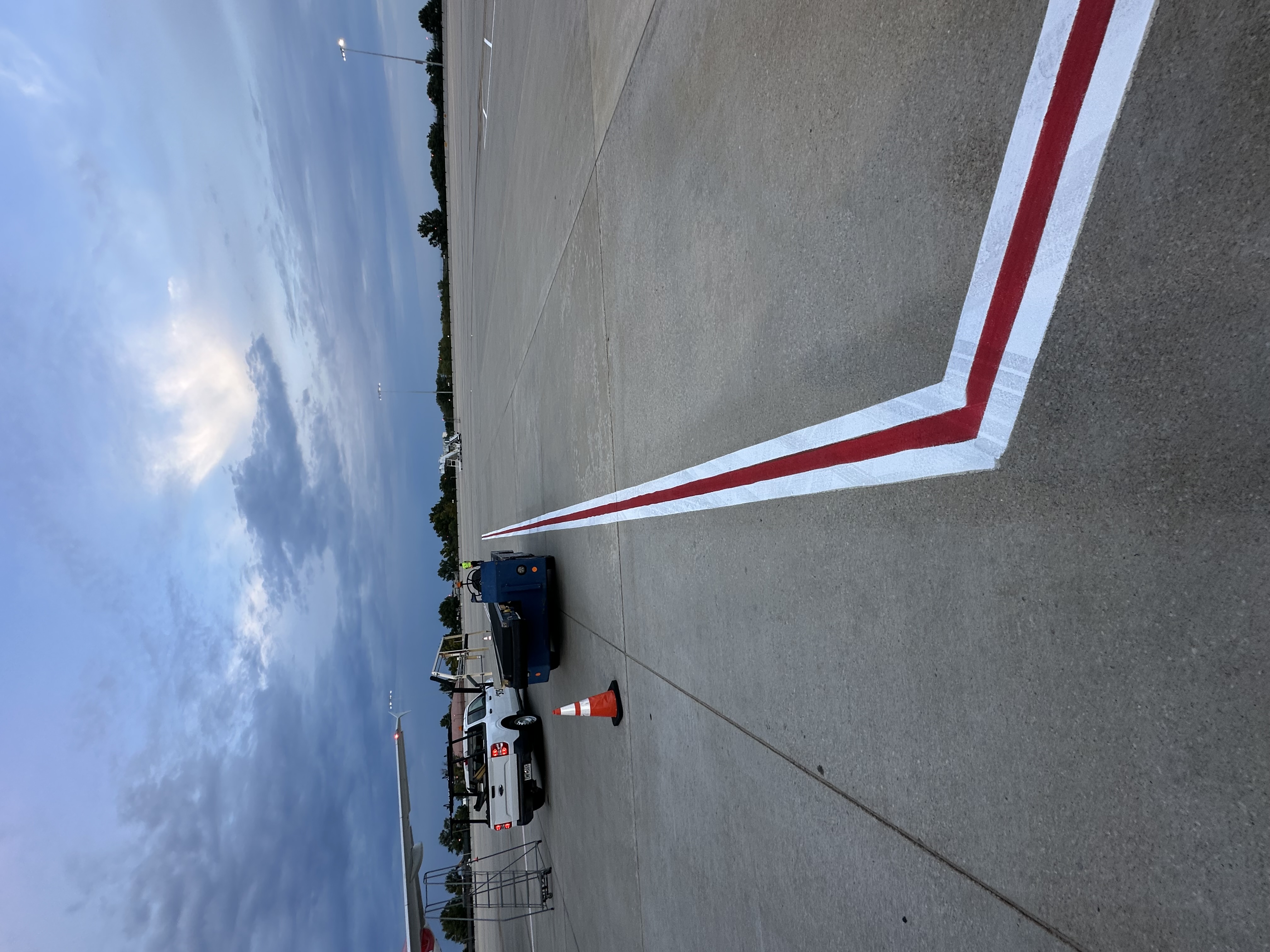 Long red boundary stripe with white contrast borders across the apron